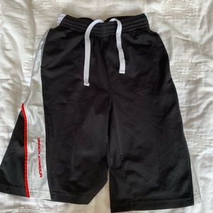Black, red, and white under armour shorts.